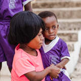 An African mother in Ghana holds her young son